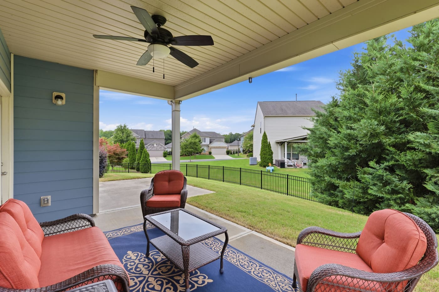 From under the rear porch, looking out across the yard to the tree line.